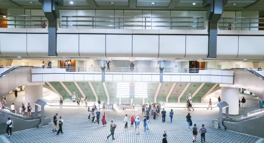 An interior view of the ICC, with people moving through the hall.