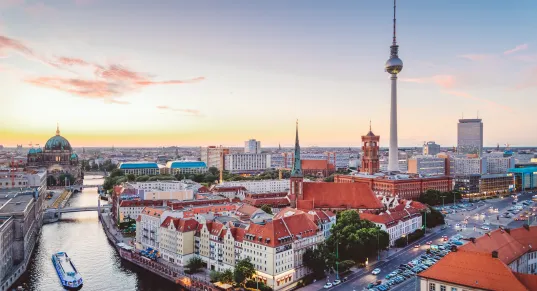 Berlin cityscape at sunset with the TV Tower and Spree River.