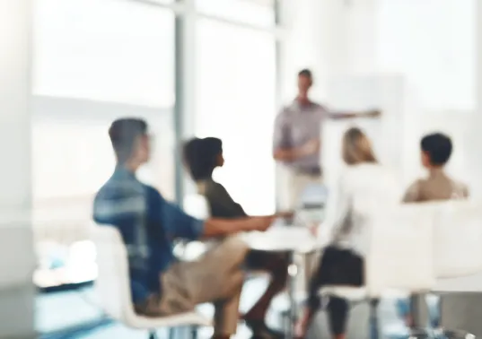 Defocused shot of a group of businesspeople having a meeting in an office