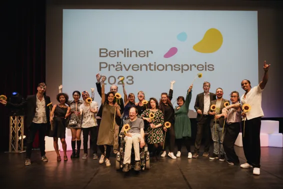 Gruppenfoto der Gewinner:innen des Berliner Präventionspreises 2023 auf der Bühne.