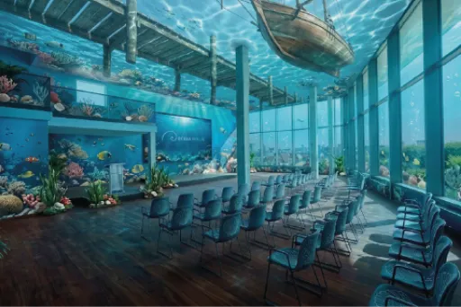 Unterwasser-Konferenzraum von OCEAN BERLIN mit Reihen bestuhlter Plätze, großen Panoramafenstern und farbenfrohen Korallenriffen und Fischen im Hintergrund (mit KI erstellter Ansichtsentwurf).