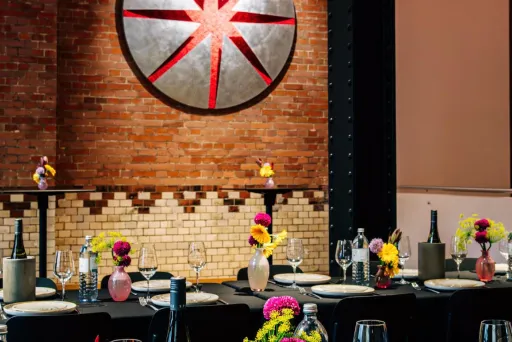 Dinner an langen Tafeln vor der historischen Backsteinwand der Edison-Höfe, Blumen von Zinnober Blumen