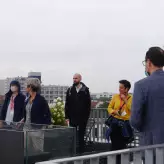 Participants gathering on the rooftop terrace of Novotel Berlin Tiergarten in rain coats
