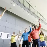Business people dancing in the office and energizing themselves
