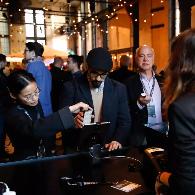 Participants of the Q 2018 event check in digitally with their mobile phones