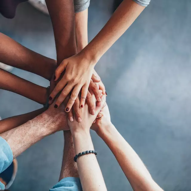 Stack of hands showing unity