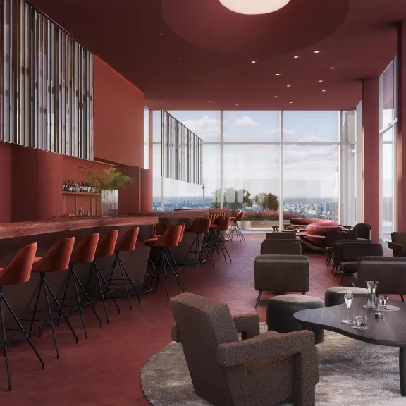 Moderne Bar mit roten Wänden, hohen Fenstern und gemütlichen Sitzbereichen.