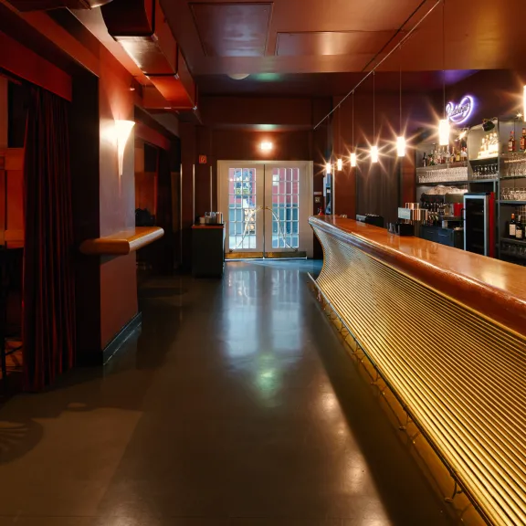 Blick auf den Eingang und ins Foyer des Chamäleon mit Bar zur rechten Seite und Saal links. 