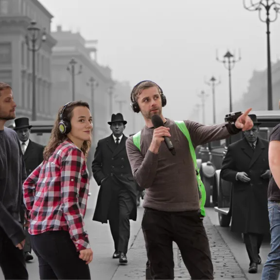 AI-Visualisierung einer Zeitreise Tour: Teilnehmende mit Kopfhörern stehen mit Live-Guide vor einer historisch inszenierten Stadtszene im Stil der 1920er-Jahre.