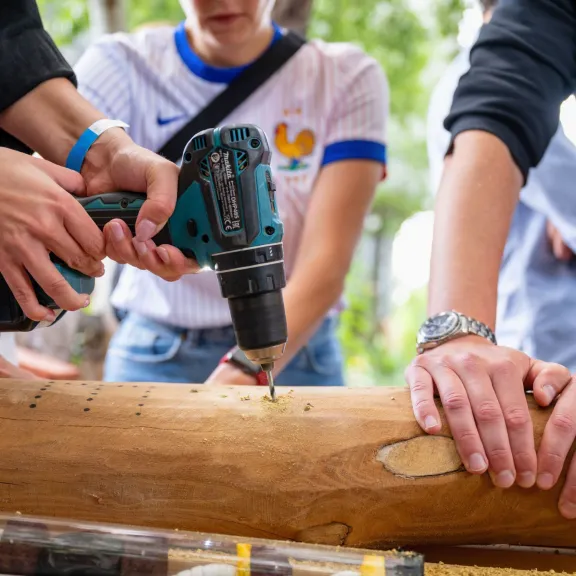 Menschen bauen eine Nisthilfe für Wildbienen