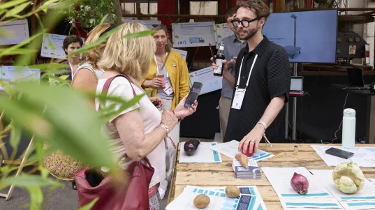 Exhibitor conversing with two customers