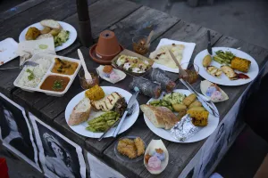 A wooden platform on which various plates with different dishes are placed