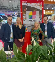 Four people stand together at the visitBerlin booth during the IBTM trade fair