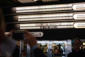 People photographing the illuminated ceiling signs in the ICC, which display event rooms and directions