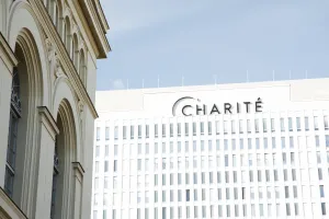 Modern façade of the Charité next to a historic building in daylight.