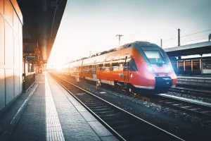 Modern regional train at a station platform during sunset in Germany.