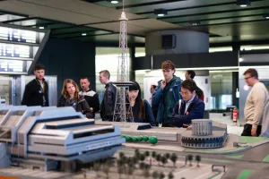 Visitors viewing an architectural model in the ICC Berlin during the 49th ICC.