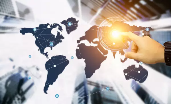 Businessman uses his finger to operate the screen of the world map demonstrating networking