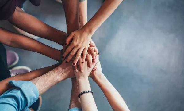 Stack of hands showing unity