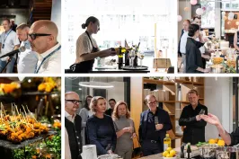 Menschen bei einem Koch-Event, Gespräche und Essenszubereitung in moderner Küche.