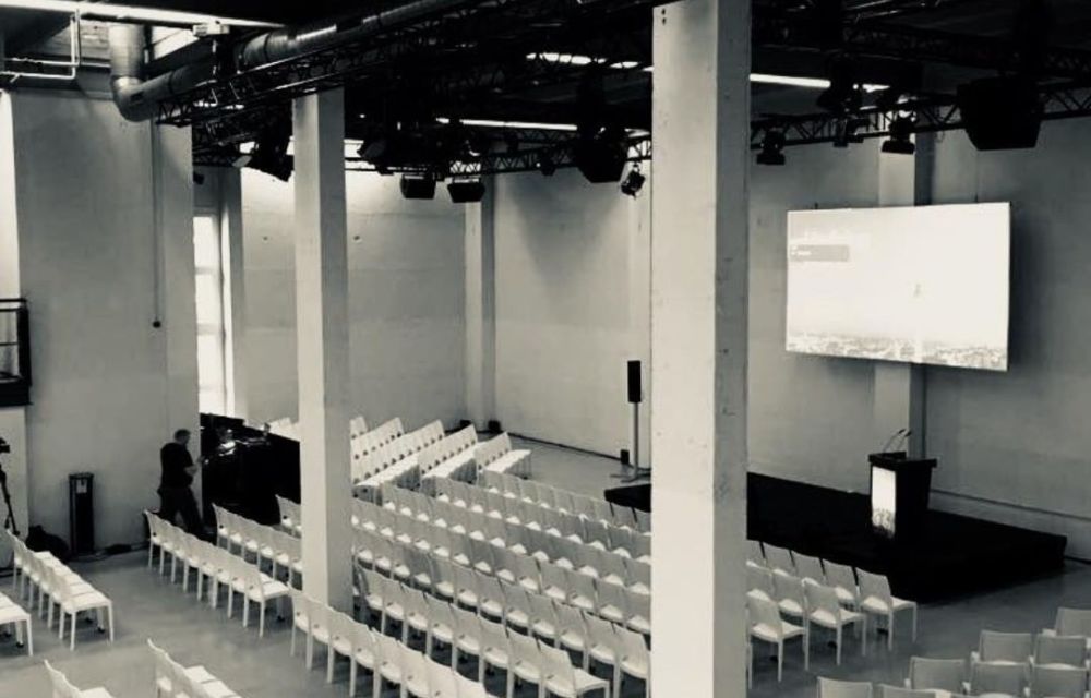 Event hall with white chairs in a row