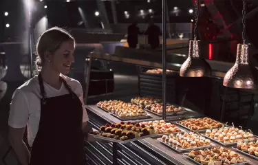 waitress in front of aveato catering buffet
