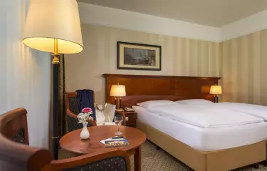 Hotelzimmer mit Doppelbett und Sitzmöglichkeiten