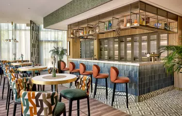 Durchgang mit Stühlen und Tischen und einer Bar an der linken Seite