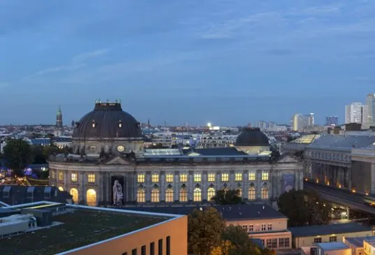 Berlin city skyline at dusk with the TV Tower and historic buildings.