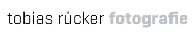 Logo text: "tobias rucker fotografie" with "fotografie" in bold gray.