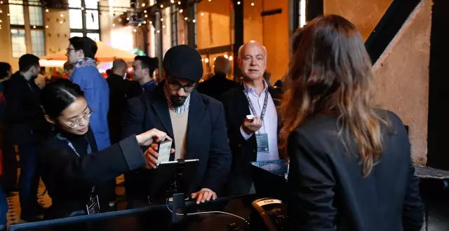 Participants of the Q 2018 event check in digitally with their mobile phones