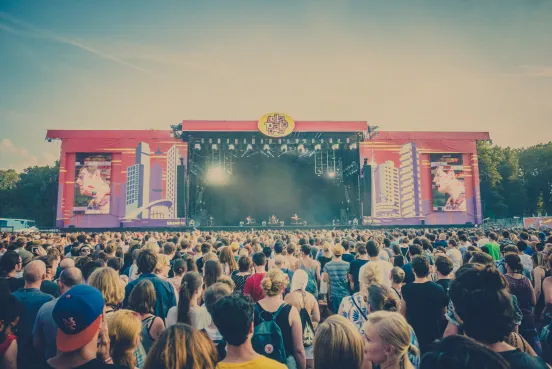 Große Menschenmenge vor einer Open-Air-Bühne bei einem Musikfestival.