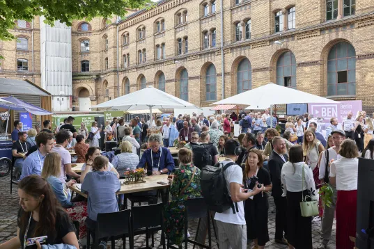 A courtyard with lots of people chatting to each other