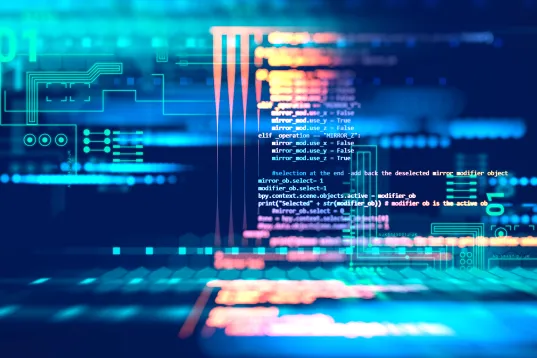 Computer code on screen with colorful blue and orange data patterns.