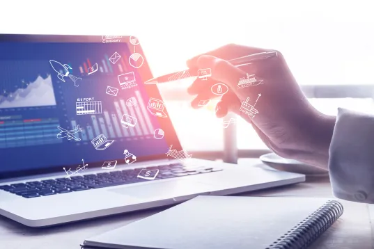 Digital analysis: Hand interacts with virtual symbols via laptop with diagrams and data.
