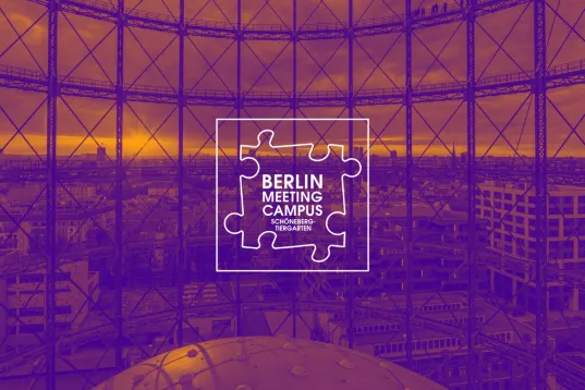 View through the Gasometer in Berlin-Schöneberg with city panorama and Berlin Meeting Campus logo